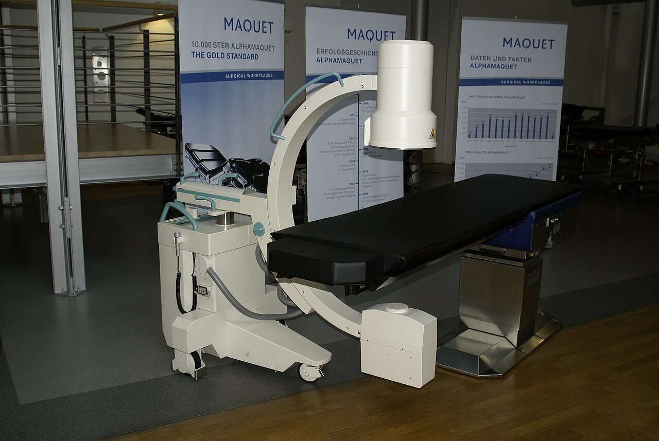 C-arm X-ray system beside a radiolucent operating table