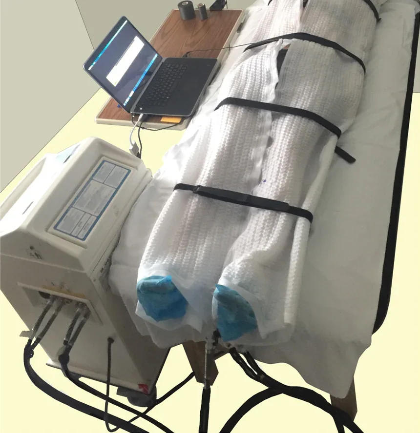 Blanketrol III water-circulating temperature-control unit beside connected blankets in a research setup