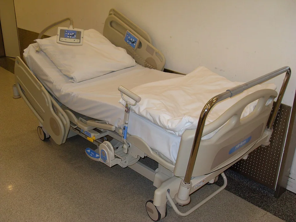 Adjustable hospital bed with side rails and controls