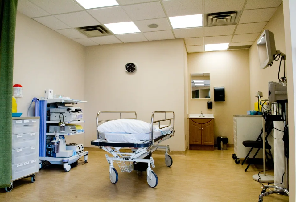 An endoscopy room with an Olympus equipment tower, procedure trolley and display monitors.