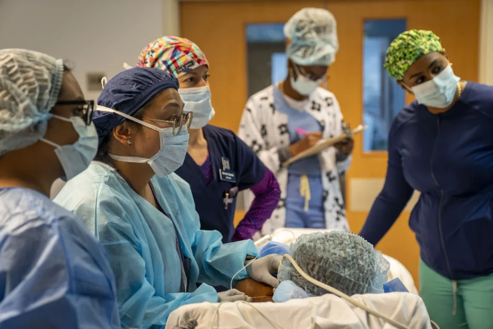 A medical team using an ultrasound probe during a nerve-block procedure in Saint Lucia.